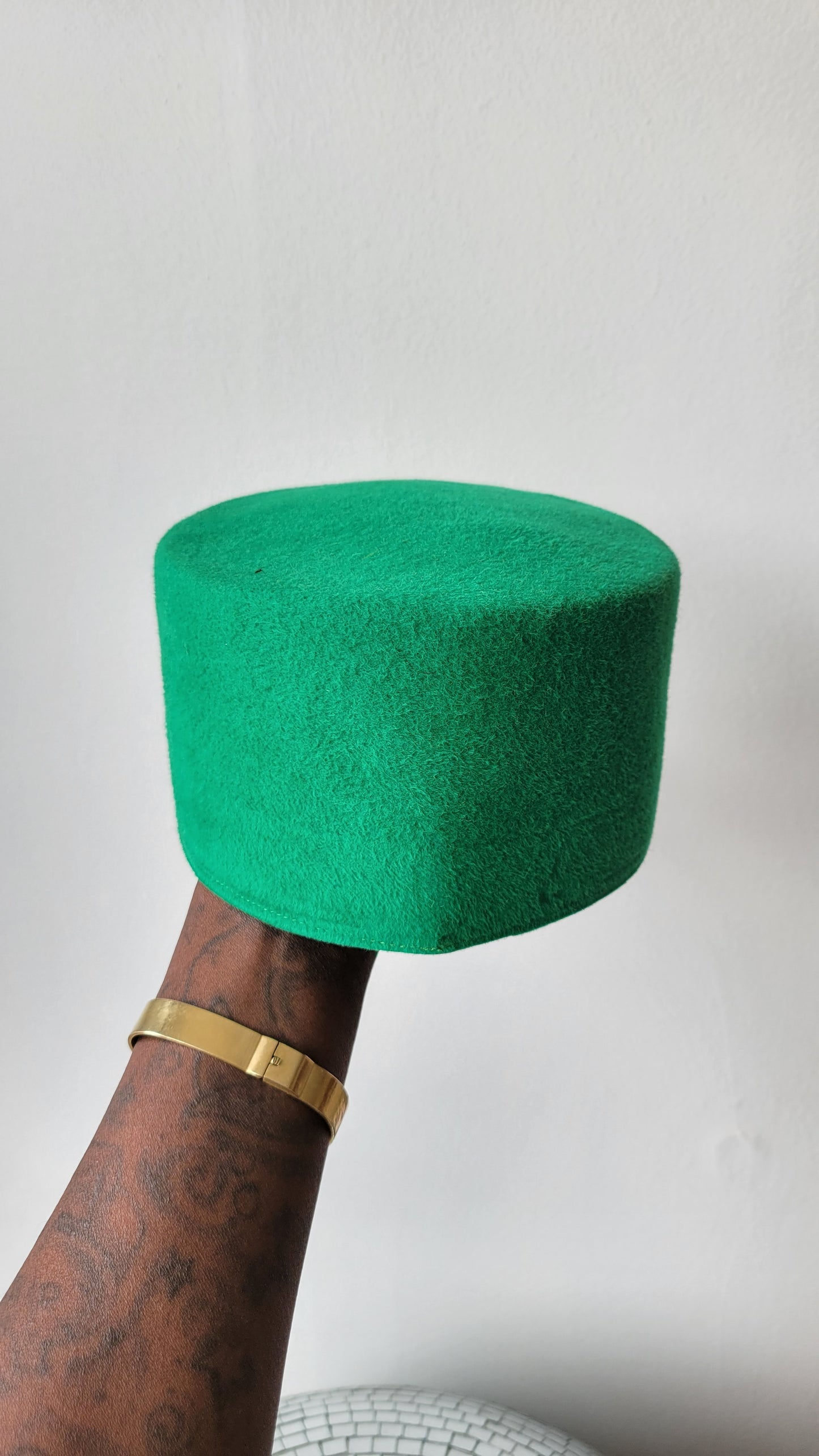 The Rhea Cap in grass green